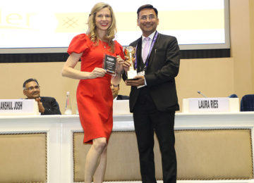 Dr. Lalit Arora receiving an award on stage