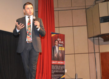Dr. Lalit Arora speaking on stage